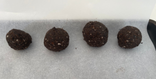 Four seed bombs sit on baking paper.