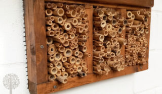 An insect hotel made from wood and bamboo.